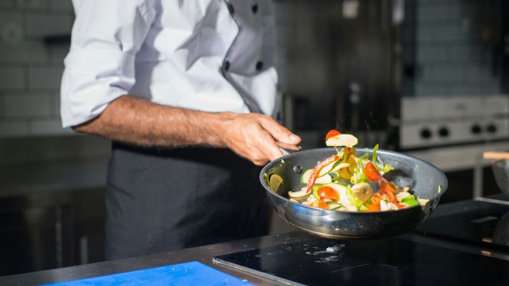 Tossing ingredients to master how to cook with a wok.