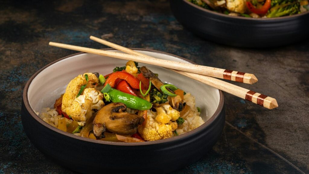 uthentic stir fry presentation with chopsticks.