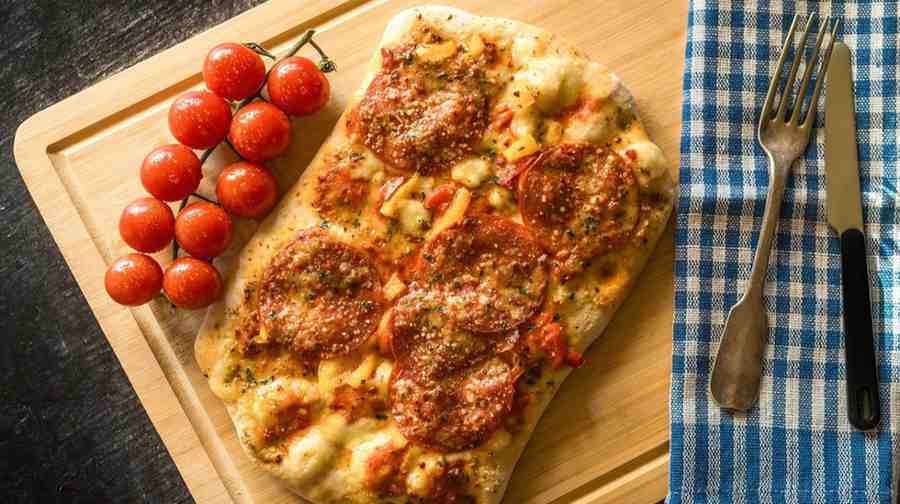 Adding the Iconic Crispy Cheese and Onion Topping