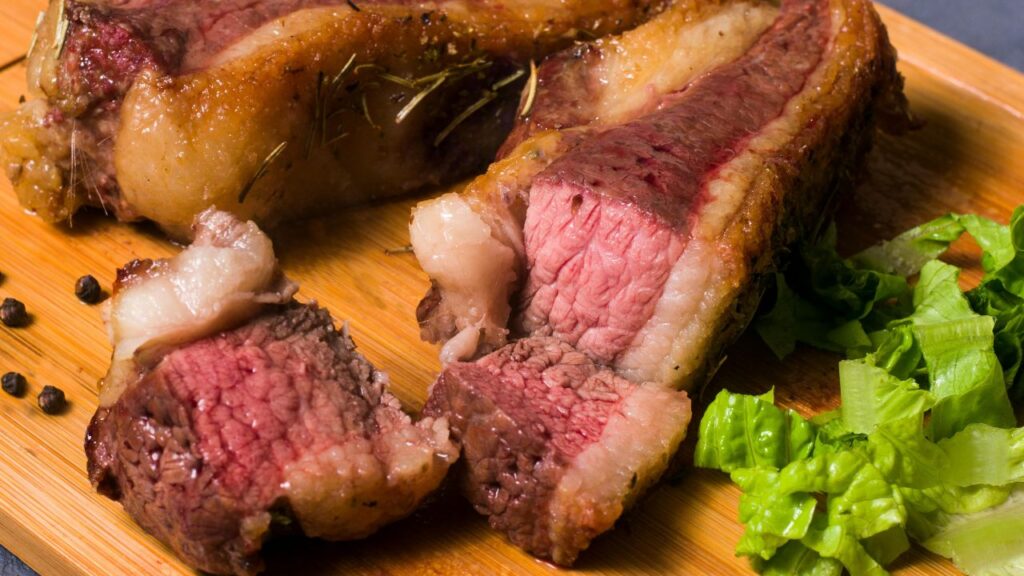 A broken-open homemade chicken nugget revealing juicy white meat and a crispy exterior coating.