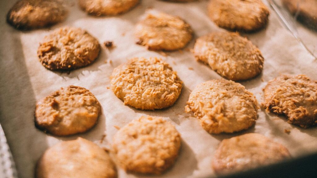 Breaded uncooked chicken nuggets arranged on a baking sheet for storage and freezing.