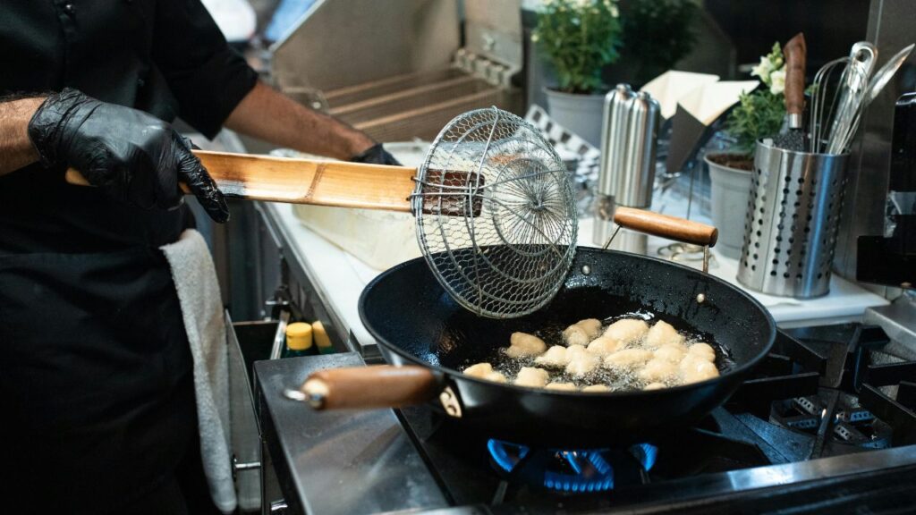 Golden-brown frying saucers shallow frying in a skillet with the perfect oil temperature for a crispy texture.
