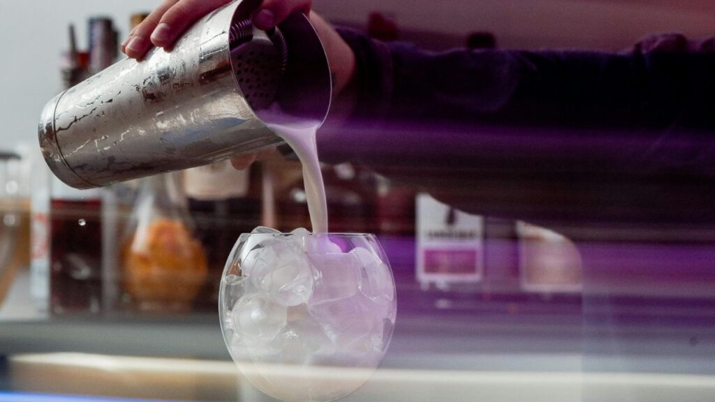 Shaking creamy cheesecake shot mixture with ice
