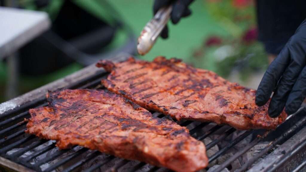 Smoking rib tips slowly inside a backyard smoker